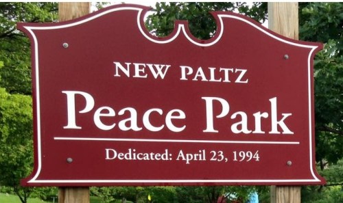 Red and white sign reads: New Paltz Peace Park. Dedicated: April 23, 1994