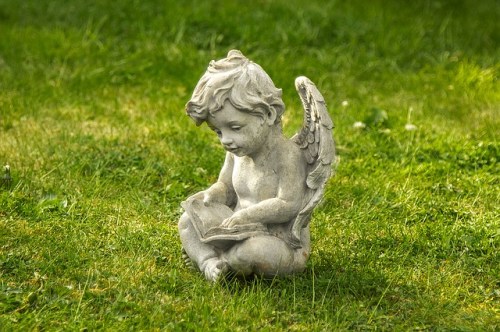 angel/cherub statue reading a book on the grass - https://pixabay.com/en/the-statue-of-angel-art-boy-1398281/
